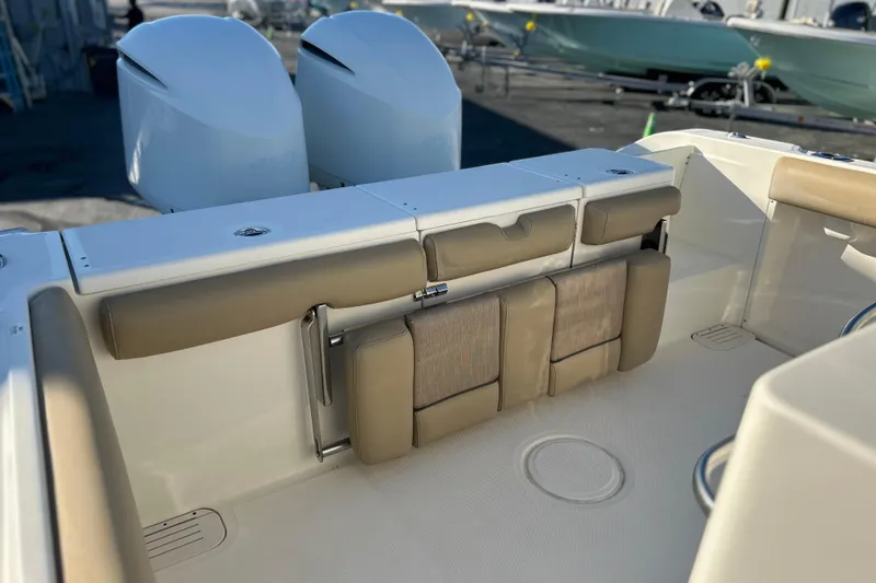 Slide: The Image of 2017 Key West Billistic 281 Center Console boat interior with cushioned seating and dual engines. - 8