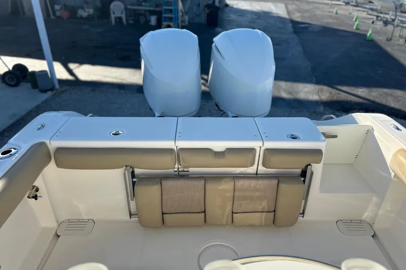 Slide: The Image of 2017 Key West Billistic 281 Center Console boat with dual engines and seating area. - 9