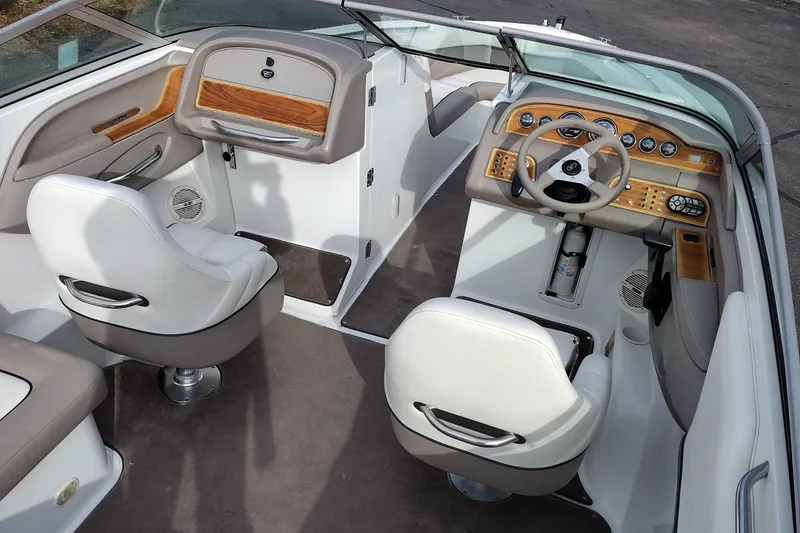 Slide: The Image of Interior of a 2000 Cobalt 246 boat with white seats and wood accents. - 11