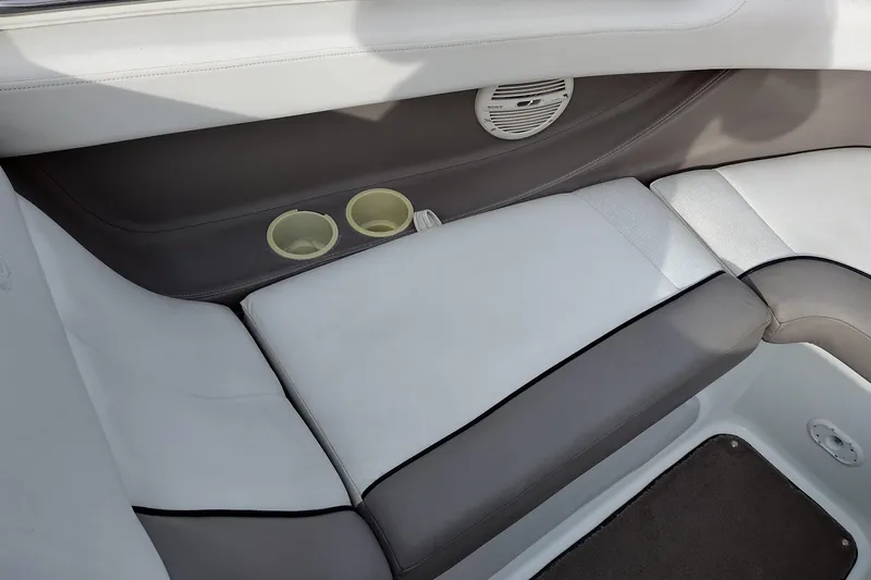 Slide: The Image of Interior of a 2000 Cobalt 246 boat with cushioned seating and cup holders. - 15