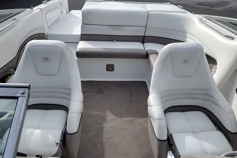 Slide: The Image of Interior of a 2000 Cobalt 246 boat with white leather seating. - 16
