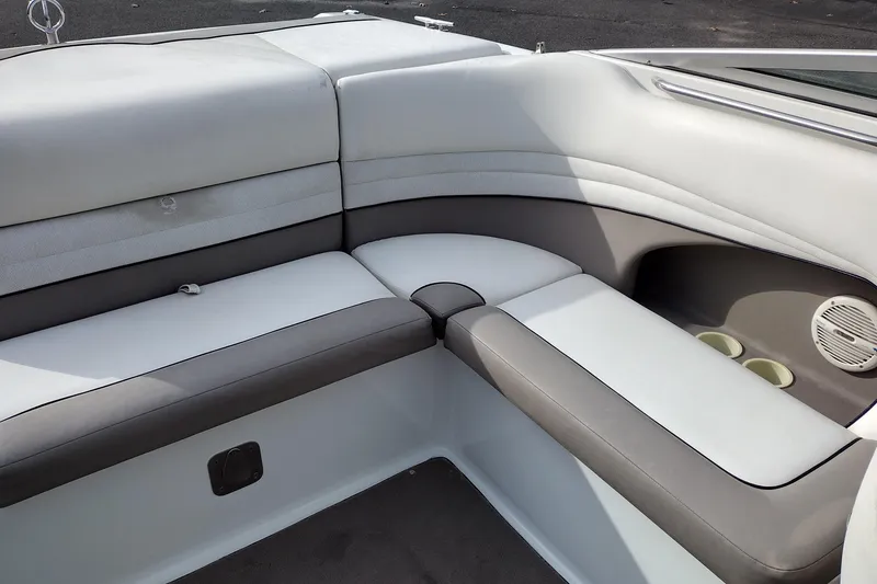 Slide: The Image of Interior seating of a 2000 Cobalt 246 boat, featuring gray and white upholstery. - 19