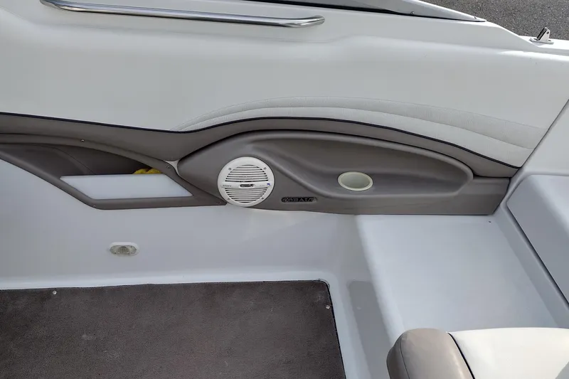 Slide: The Image of Interior of a 2000 Cobalt 246 boat, featuring speaker and cup holder. - 20