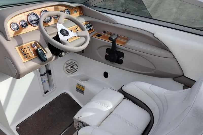 Slide: The Image of Interior of a 2000 Cobalt 246 boat, featuring a sleek dashboard and steering wheel. - 22