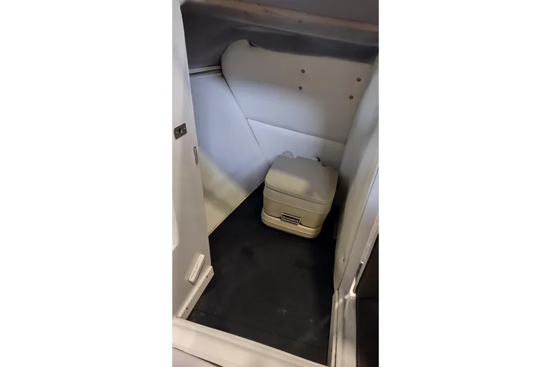 Slide: The Image of Compact boat restroom with portable toilet in 2000 Cobalt 246. - 32