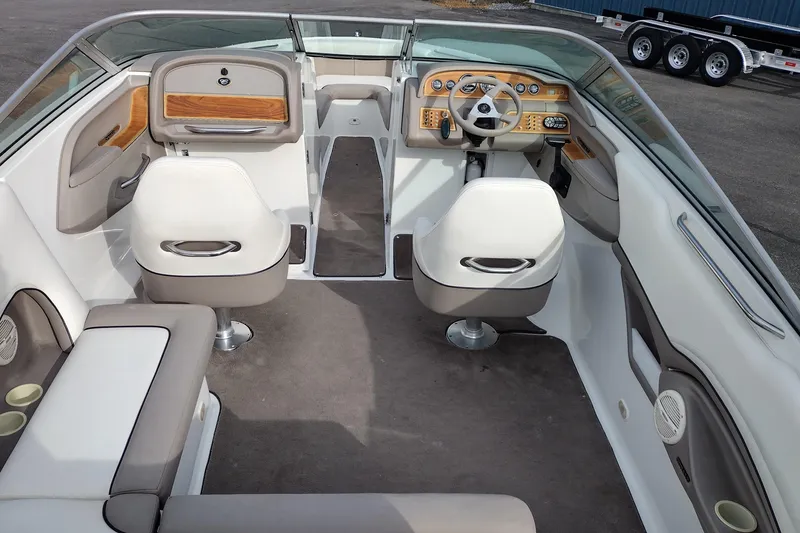 Slide: The Image of Interior of a 2000 Cobalt 246 boat with white seating and wood accents. - 9