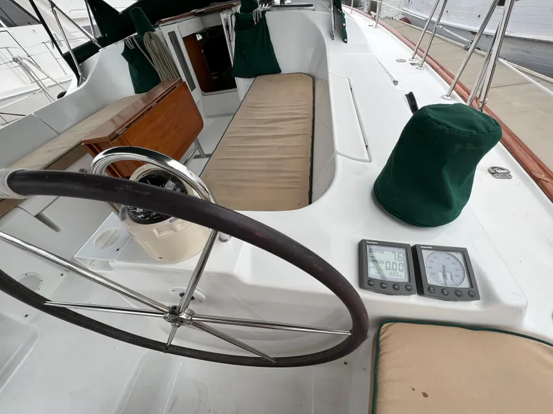 Slide: The Image of 2004 Beneteau 473 sailboat cockpit with steering wheel, instruments, and seating. - 11