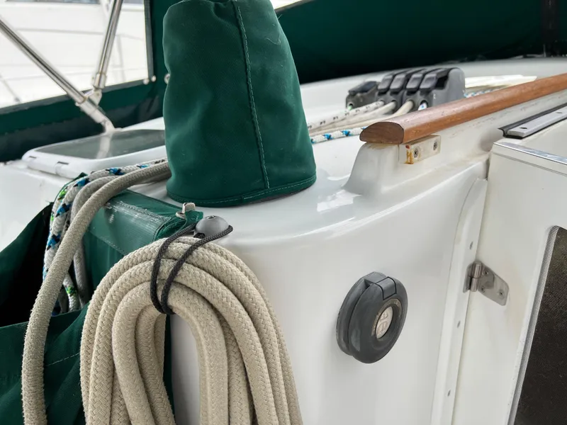 Slide: The Image of 2004 Beneteau 473 sailboat deck with ropes and green canvas cover. - 20