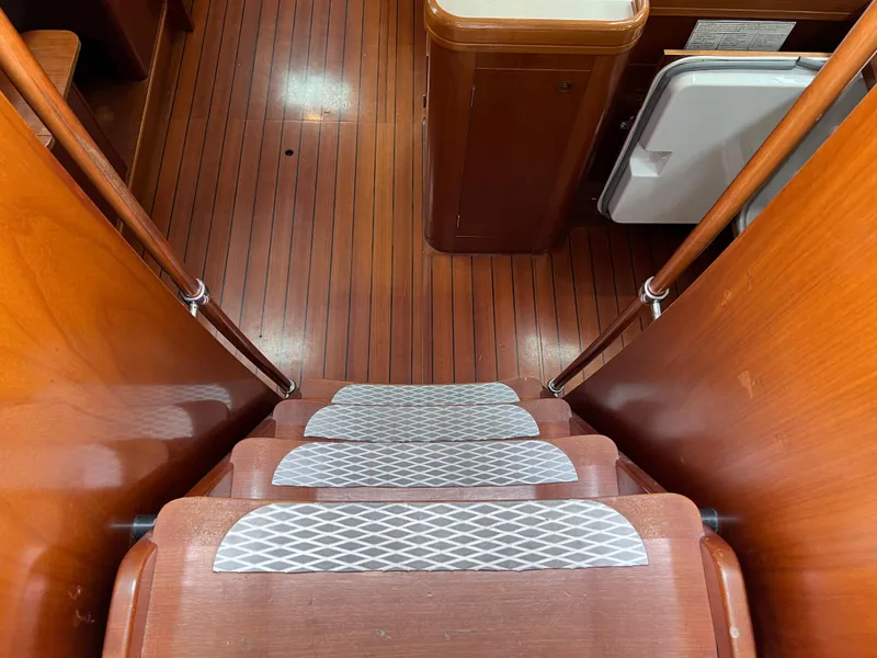 Slide: The Image of Staircase inside 2004 Beneteau 473 yacht with wooden flooring and white anti-slip pads. - 30