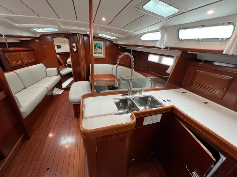 Slide: The Image of Luxurious interior of a 2004 Beneteau 473 yacht with wood finish and modern amenities. - 32