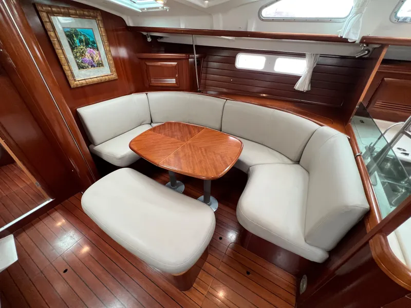Slide: The Image of Luxurious 2004 Beneteau 473 yacht interior with elegant wood finish and plush seating. - 40