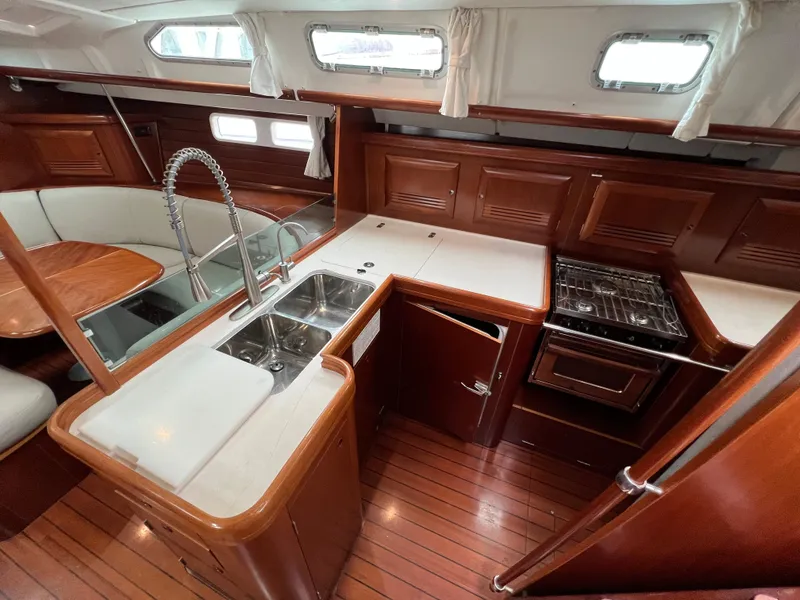 Slide: The Image of Luxurious 2004 Beneteau 473 yacht interior with modern kitchen and dining area. - 41