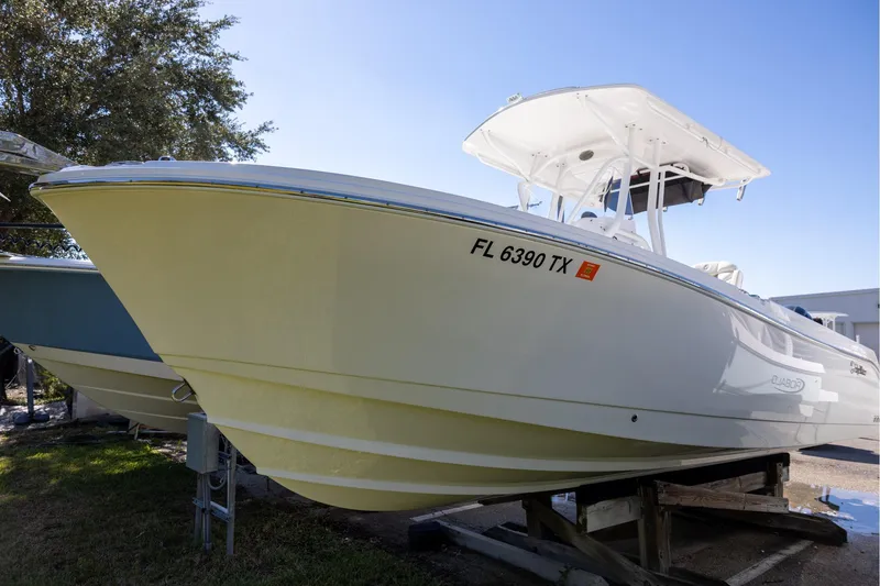 The Image of 2023 Edgewater 245CC boat on display, white hull, registration FL 6390 TX. - 0