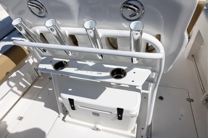 Slide: The Image of 2023 Edgewater 245CC boat with rod holders and cooler storage. - 6