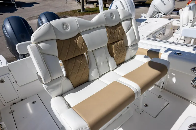 Slide: The Image of 2023 Edgewater 245CC boat with luxurious tan and white seating. - 8
