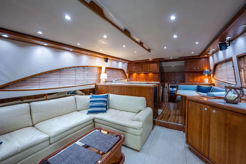 Slide: The Image of Luxurious interior of a 2008 Bertram 570 yacht with elegant wood finishes and cozy seating. - 26