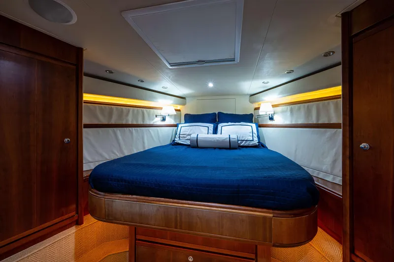 Slide: The Image of Luxurious cabin interior of 2008 Bertram 570 yacht with elegant bedding and warm lighting. - 38