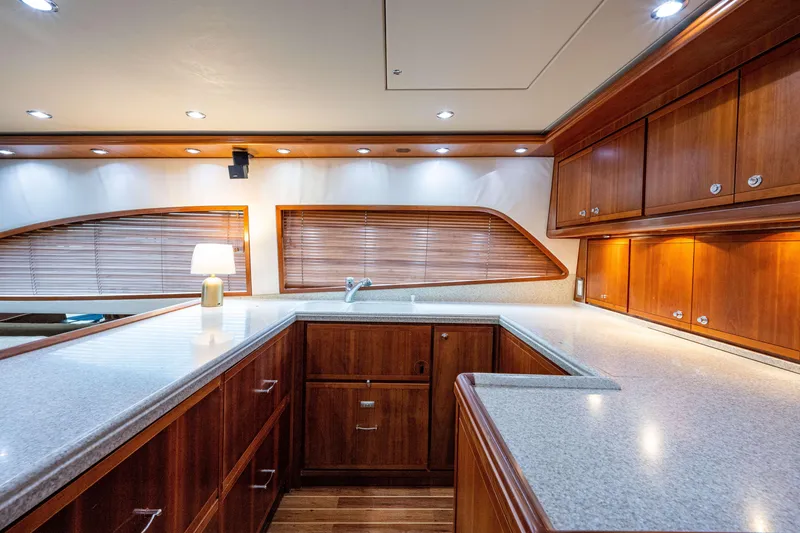 Slide: The Image of Luxurious 2008 Bertram 570 yacht interior with elegant wood cabinetry and modern lighting. - 34