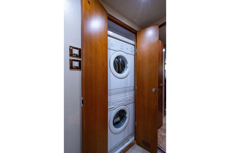Slide: The Image of Stacked washer and dryer in 2008 Bertram 570 yacht's wooden closet. - 49