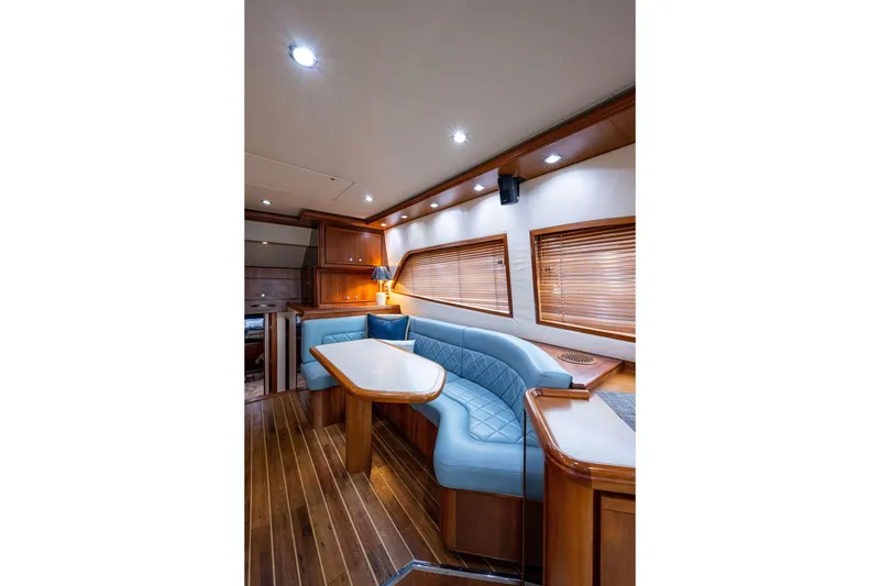 Slide: The Image of Luxurious interior of 2008 Bertram 570 yacht with elegant wood and blue seating. - 23