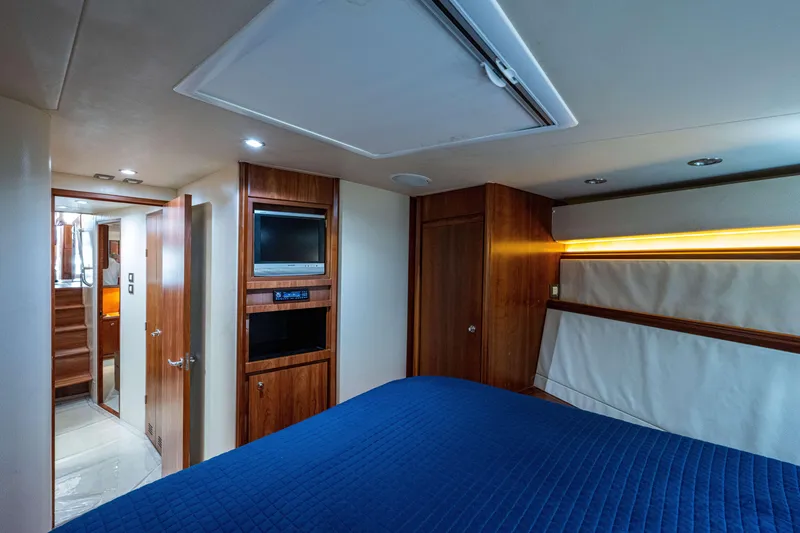 Slide: The Image of Luxurious 2008 Bertram 570 yacht interior with wood paneling and modern amenities. - 40