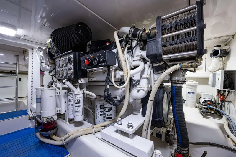 Slide: The Image of Engine room of a 2008 Bertram 570 yacht, featuring CAT machinery and components. - 63