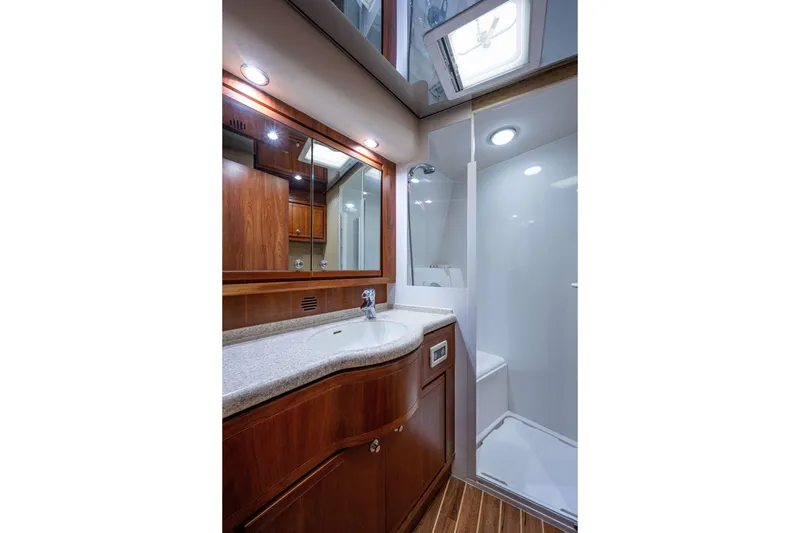Slide: The Image of Luxurious bathroom in 2008 Bertram 570 yacht with wooden cabinetry and modern fixtures. - 51