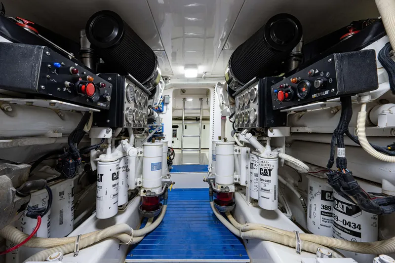 Slide: The Image of Engine room of a 2008 Bertram 570 yacht, featuring Caterpillar machinery and controls. - 61