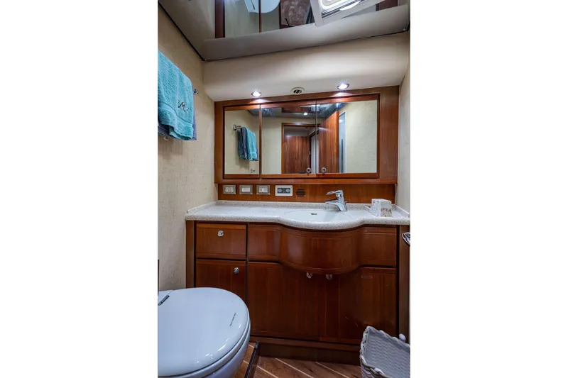 Slide: The Image of Luxurious bathroom in a 2008 Bertram 570 yacht with wooden cabinetry and modern fixtures. - 39