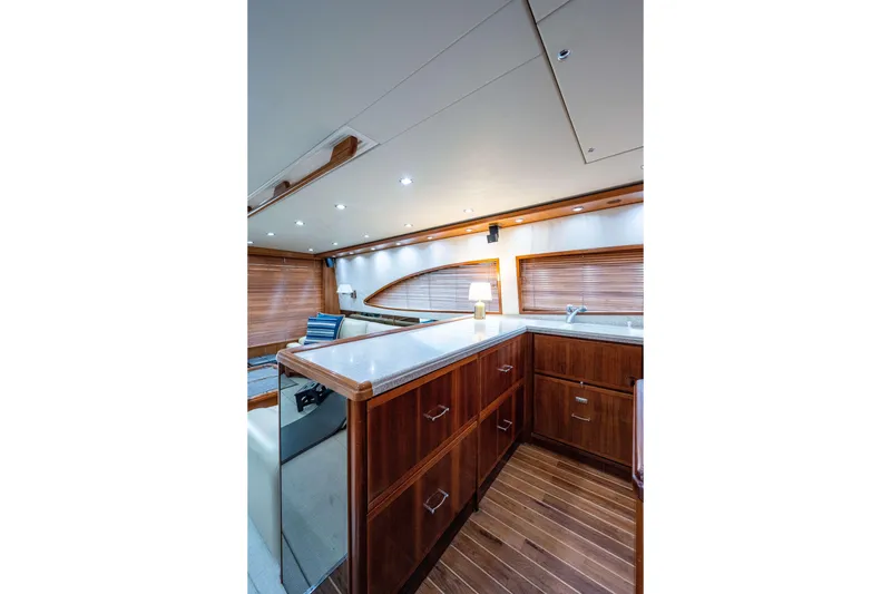 Slide: The Image of Luxurious interior of a 2008 Bertram 570 yacht with elegant wood finishes. - 33