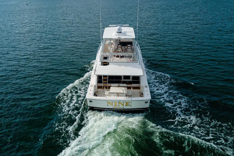 Slide: The Image of 2008 Bertram 570 yacht cruising on open water, rear view. - 4