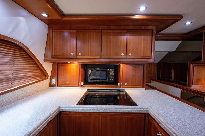 Slide: The Image of Luxurious 2008 Bertram 570 yacht kitchen with wooden cabinets and modern appliances. - 36