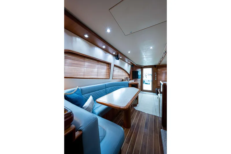 Slide: The Image of Luxurious interior of 2008 Bertram 570 yacht with elegant seating and wooden accents. - 25