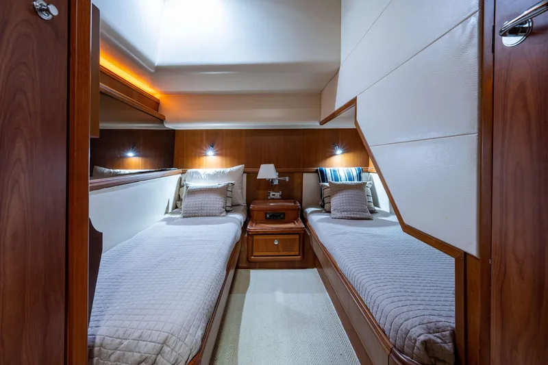 Slide: The Image of Luxurious twin cabin interior of 2008 Bertram 570 yacht with elegant wood finish. - 46