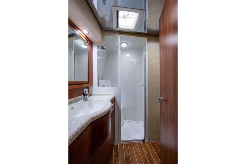 Slide: The Image of Luxurious bathroom in 2008 Bertram 570 yacht with modern fixtures and wooden accents. - 50