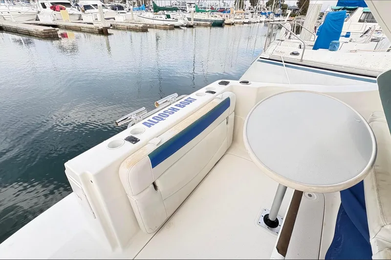Slide: The Image of 2007 Bayliner 285 boat with seating and table, docked at a marina. - 11