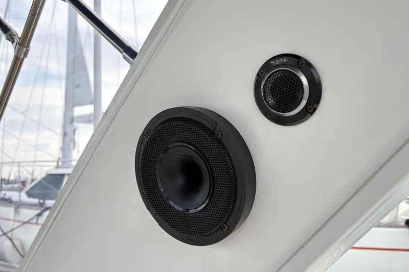 Slide: The Image of 2007 Bayliner 285 boat speakers on deck, with marina background. - 12