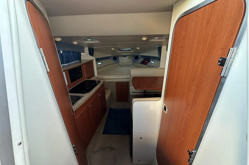 Slide: The Image of 2007 Bayliner 285 interior with kitchenette, seating, and sleeping area. - 15