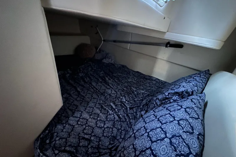 Slide: The Image of Cozy cabin interior of 2007 Bayliner 285 with patterned bedding. - 17