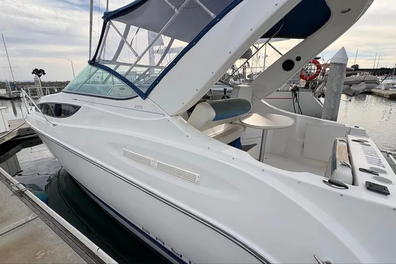 Slide: The Image of 2007 Bayliner 285 boat docked at marina, featuring sleek design and spacious deck area. - 3