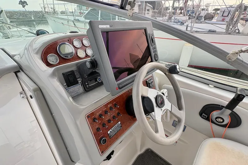 Slide: The Image of 2007 Bayliner 285 boat cockpit with steering wheel, gauges, and navigation screen. - 6