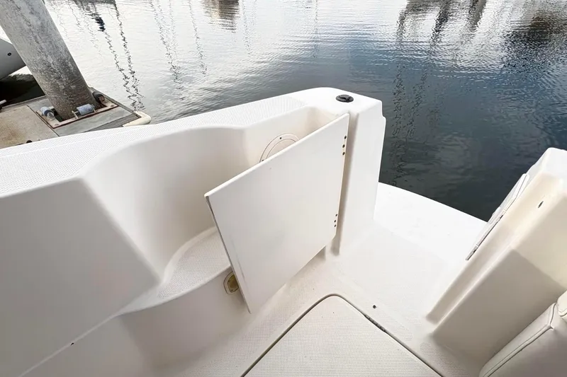 Slide: The Image of 2007 Bayliner 285 boat interior with open storage compartment by the water. - 8