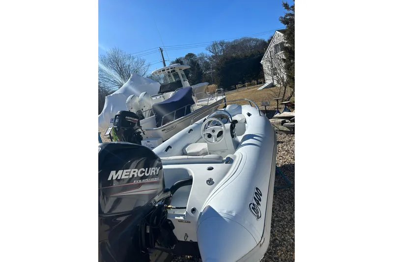 Slide: The Image of 2018 Mercury Inflatables M 400 HP boat with Mercury FourStroke engine, parked outdoors. - 5