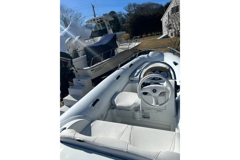 Slide: The Image of 2018 Mercury Inflatables M 400 HP boat with white interior and steering wheel. - 6