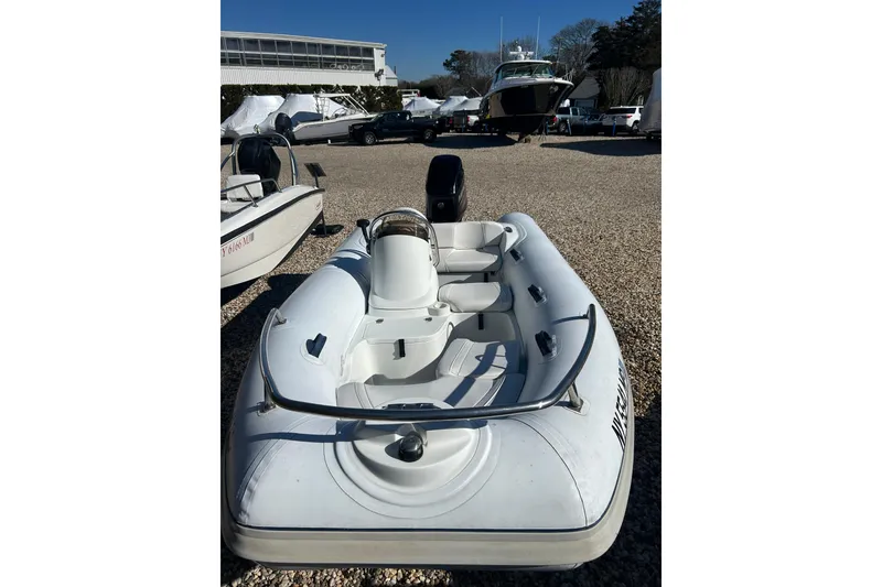 Slide: The Image of 2018 Mercury Inflatables M 400 HP boat with white interior and steering console. - 8