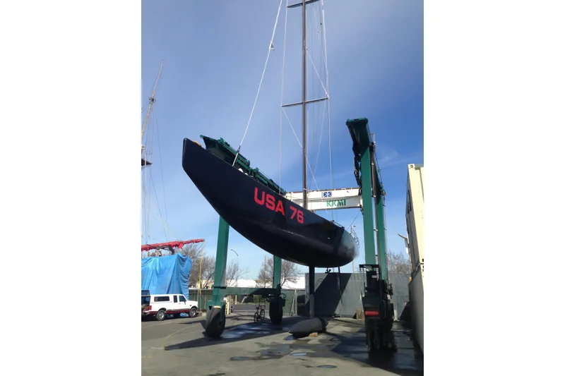 Slide: The Image of Sailboat USA 76, 2002 International Americas Cup Class, lifted by crane at dockyard. - 14