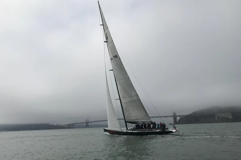 Slide: The Image of Sailing yacht on foggy waters near a bridge, 2002 International Americas Cup Class. - 16