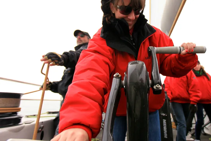 Slide: The Image of Crew members operating winches on a 2002 Custom International Americas Cup Class yacht. - 25