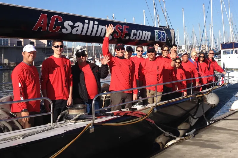 Slide: The Image of Group in red shirts on 2002 International Americas Cup Class yacht at marina. - 29
