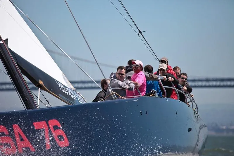 Slide: The Image of Sailing crew on 2002 Custom International Americas Cup Class yacht, USA 76, near a bridge. - 35